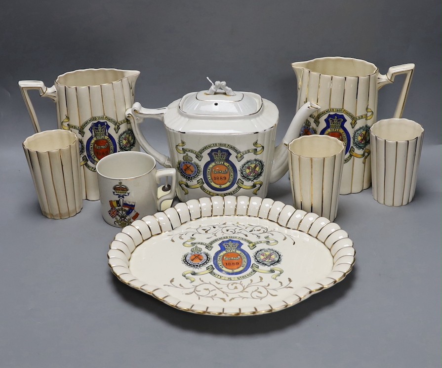 National Rifle Association Wimbledon 1889 - A group of Staffordshire commemorative pottery, including two water jugs, 18 cm high, and three matching beakers, a teapot and cover, a tray, together with a WW1 mug